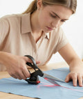 Person using Laser Guided Scissors for Fabric and Paper Cutting, Infrared Laser Line for Crisp Straight Cuts