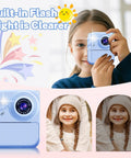 Kid Friendly Instant Print Camera With 1080P Video Includes 3 Print Rolls Inkless Thermal Paper For Safe Printing BPA Free Build One-Touch Snap And Print Durable Fun Camera For Creative Photos And Quick BW Prints. Blue kids instant print camera shown front view with child holding it