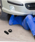 Mechanic under car with Durable Plastic Spare Tire Hold Down Bolt For Secure Mounting, Easy Installation beside on the floor