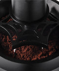 Close-up of 58mm Electric Espresso Stirrer And Wdt Tool with fine needles mixing coffee grounds in a portafilter.