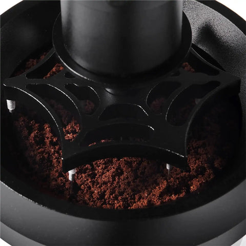 Close-up of 58mm Electric Espresso Stirrer And Wdt Tool with fine needles mixing coffee grounds in a portafilter.