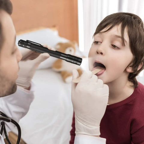 Doctor using Rechargeable Pen Flashlight With USB Charging Ultra Compact 5.7 Inch EDC Light on child for throat examination.