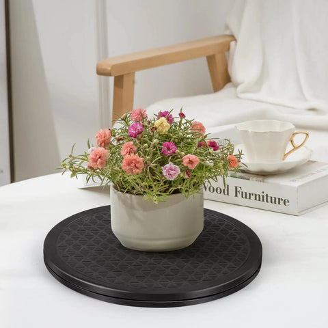 Heavy Duty Lazy Susan 10 Inch With Steel Ball Bearings spins a flower pot on a black turntable with a stylish cup in background.