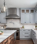 Modern kitchen with Chrome Pot Filler Faucet Wall Mount With Dual Handles And Double Joint Swing Arms visible above the stove.