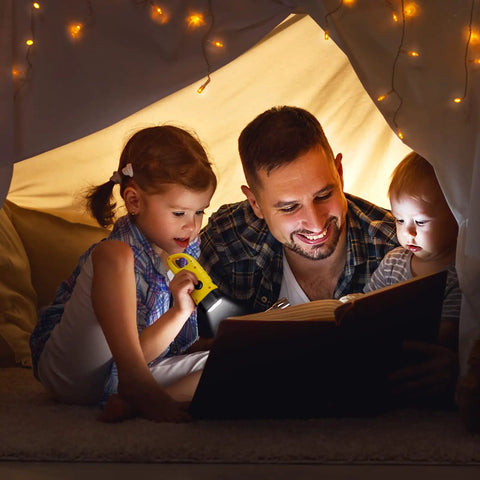 Family reading with Four Pack Hand Crank Solar Powered Flashlights With Rechargeable LED Lighting Emergency Torches in a cozy tent.