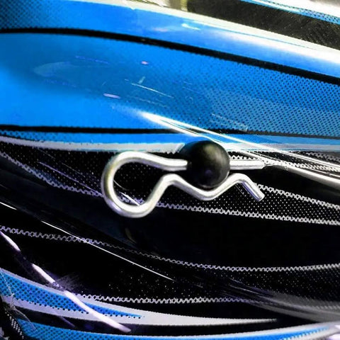Close-up of a single M3 60mm zinc-plated cotter pin R clip hairpin for trailer hitch systems with blue background