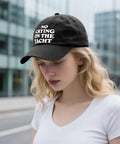 Woman wearing No Crying On The Yacht Trucker Hat For Son Funny Nautical Cap With Adjustable Strap Casual Outdoor Wear For Travel Photos And Everyday Adventures For Everyday Use, black color, urban background.