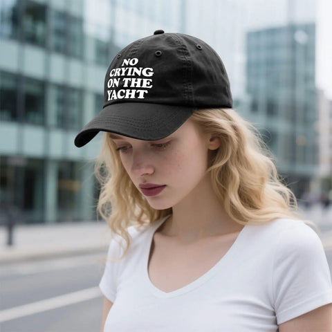 Woman wearing No Crying On The Yacht Trucker Hat For Son Funny Nautical Cap With Adjustable Strap Casual Outdoor Wear For Travel Photos And Everyday Adventures For Everyday Use, black color, urban background.