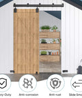 Heavy Duty Exterior Barn Door Hardware Kit For Outdoor Use With Box Rail Sliding Track Built To Last And Tough As Nails And Supports Up To 450 Lbs For One Door Black Finish Weather Resistant And Rustproof Ideal For Sheds Stables Garages And Workshops installed on a wooden door in outdoor setting