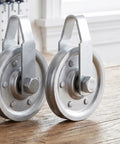 Heavy Duty Garage Door Pulley Kit With 3 Inch Sheave Wheels Two Clevis Fork Pulleys And Two Stationary Sheaves Crafted From Rock Solid Galvanized Steel, close-up of galvanized steel pulleys.