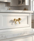 Top Shelf Vintage Bowknot Cabinet Knobs And Metal Drawer Pulls For Furniture Hardware decorative gold bowknot handle on white drawer.