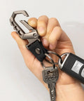 Hand holding Heavy Duty Key Chain With Bottle Opener, Tough Car Keychain Set Featuring Metal Snap Hook Carabiner Clip, Dual Key Rings