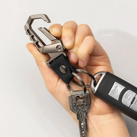 Hand holding Heavy Duty Key Chain With Bottle Opener, Tough Car Keychain Set Featuring Metal Snap Hook Carabiner Clip, Dual Key Rings