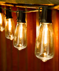 Close-up of glowing 100 Foot LED Outdoor String Lights With 52 Shatterproof Vintage Edison Bulbs For Patio Bistro Cafe And Backyard Ambience