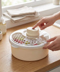 Straight Up Game Changer Electric Salad Spinner With Rapid Drain Tech That Cuts Water From Greens In Seconds, user activating motor.