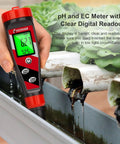 Hydroponics 4 In 1 pH Meter EC TDS Temperature Tester with digital display used in a hydroponic system for accurate readings.