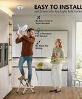 Man installing LED Light Socket Ceiling Fan With Remote in kitchen, easy screw in, no tools needed, standard socket base. Woman watching.