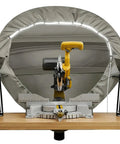 Heavy Duty Miter Saw Dust Collection Hood With LED Light Durable Gray Oxford Fabric Table Saw Dust Collector With Storage Bag Fits 10 Inch And 12 Inch Saws Ideal For Garage And Workshop Use installed behind saw.