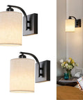 Sleek Matte Black Rechargeable Wall Sconces Set Of Two Wireless Dimmable Led Lights With Remote Easy Setup For Bedroom And Living Room All Day Battery Operated Lamps Heavy Duty Build Badass Style mounted beside a bed with remote.