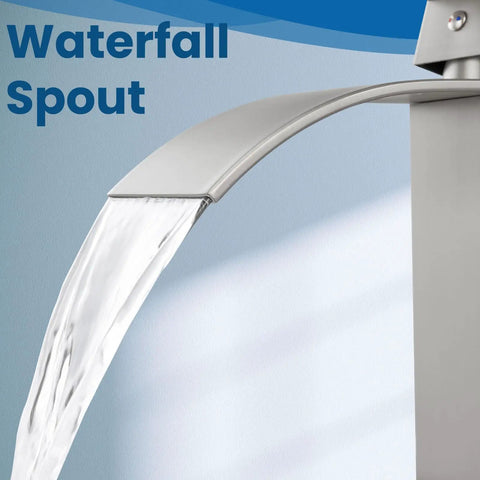 Close-up of tall vessel sink faucet with waterfall flow spout, single handle mixer tap in brushed nickel for bathroom vanity.