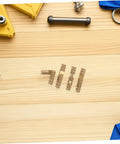 25 Pcs Mini Brass Barrel Hinges for Jewelry Boxes and Wooden Cabinet Doors, hidden cylindrical design with tools on a wooden surface