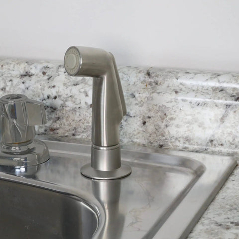 Brushed Nickel Kitchen Sink Side Spray Head 1 Pack With Easy On Off Thumb Control installed next to a faucet on a countertop