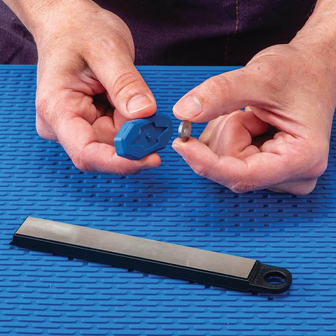 Hands holding components of Carbide Cutter Honing System With Diamond Sharpening Tool And Magnetic Grip For Carbide Inserts.