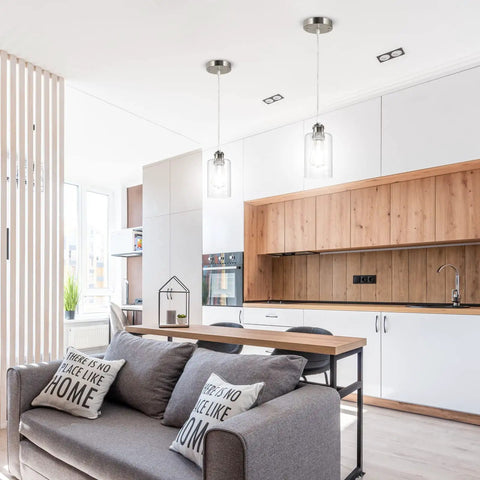Three Pack Industrial Pendant Lights for Kitchen Island And Living Areas, over modern kitchen with clear glass shades.