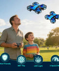 Father and son flying Mini Kids Drone For Indoors And Outdoors RC Quadcopter with Propeller Guards and LED Lights in a park