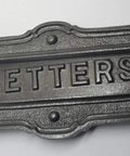 Neo Classical Cast Iron Mailbox With Swinging Letter Slot Door Wall Mounted Vintage Antique Postal Box Old School Charm, Ornate Garlands And Floral Accents, Reproduction Of 1900 Original With Weathered Iron Finish close-up of letter slot