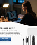 Two Pack LED Video Panel Light Kit with one light illuminating a woman on a Zoom call, USB power connection visible