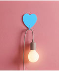 Hella Cute 10 Pack Heart Wall Hooks Super Sturdy Adhesive Mount for holding light cords on a pink wall.
