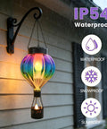 Hot Air Balloon Solar Lantern Outdoor Waterproof Hanging Glass Light With Flickering Flame Totally For Garden Backyard Patio Fence Decor Purple Gifts For Women, showing IP54 waterproof feature in rain.