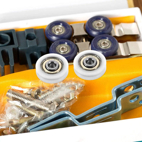 Smooth 1.5 Inch Small Ball Bearing Rollers With Deep Groove Steel Design For Skateboard Wheels And Industrial Machinery Gear, Featuring Durable Nylon Construction For Long Lasting Performance And Quick Setup Jobs displayed among screws and components.