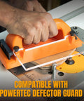 No Sweat Grip Lockdown Push Block With Retractable Holder And Traction Pad in use on router table, featuring ergonomic orange handle.