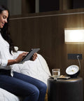 Radiant Furniture Power Center with USB and Switch Recessed Power Strip mounted on wall near bed with devices charging