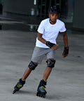 A man skating with Macroblade 80 Inline Skates For Men With Dope Fit Performance Liner Engineered Mesh Comfortable Padding in black and lime.