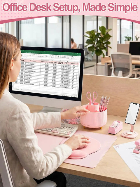 Woman using computer with Nine Piece Cute Pink Desk Accessories Set for Women with 360 Degree Rotating Pen Holder Desk Mat Wrist Rest