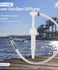 Gear Lube Pump For 32 Oz Bottles With Three Eighths Inch Swivel Adapter on a wooden dock by a lake.