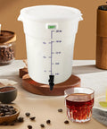 Five Gallon Round White Cold Brew Bucket System For Commercial Use With Drip Free Spigot And Recipe Guide Ideal For Home Office Or Small Coffee Spots Great For Busy Kitchens And Coffee Stations At Workplaces And Small Event Catering, shown on a countertop.