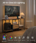 Top Shelf TV Stand And Media Console Fit For Screens Up To 55 Inches Featuring Easy Access Storage Drawers And Open Shelving Rustic Brown Steel Frame for living room with LED lighting.