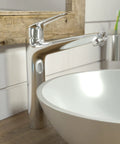 Low Flow Single Handle Tall Bathroom Sink Faucet Chrome Water Saving Modern Design 3 Hole Compatible Or Single Hole Install No Fuss Easy Clean Durable Build Model 71124001 beside a white basin