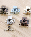 Five Pack Twin Roller Cabinet Door Catches With Screws For Home Furniture, various finishes on light wood surface