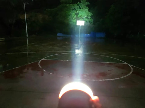 LED Camping Lantern With Magnetic Base, Rechargeable 2200 mAh Battery illuminating a basketball court at night