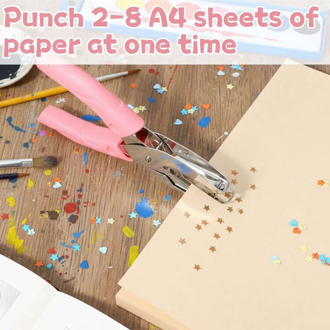 Pink Star Shaped Hole Puncher Five Millimeter With Rubber Grip Handle, used on a paper stack, crafting table background.