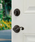 Shelburne Single Cylinder Handleset With Lido Lever And SmartKey In Venetian Bronze for exterior keyed entry on white door