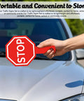 Stop And Go Traffic Sign With Handle For Kids Double Sided Red Light Green Light Crossing Guard Sign Waterproof PVC Safety Tool For Classroom And Garage Totally Easy To Use Stop Go Signal For Learning shown being held by a hand in front of a car's hood.