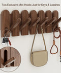 Walnut Wood Coat Rack Wall Mount With Eight Retractable Hangers And Two Dedicated Key Hooks displaying keys and a leash