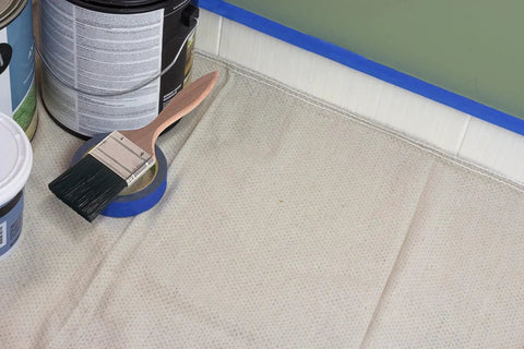 Quick Drop 8 Oz Canvas Safety Drop Cloth With Slip Resistant Dots, Heavy Duty Floor Protector with paint supplies on top