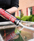 Person applying Latex Window Glazing Sealant White 10.1 Oz for wood and metal window frames to hold glass in place.